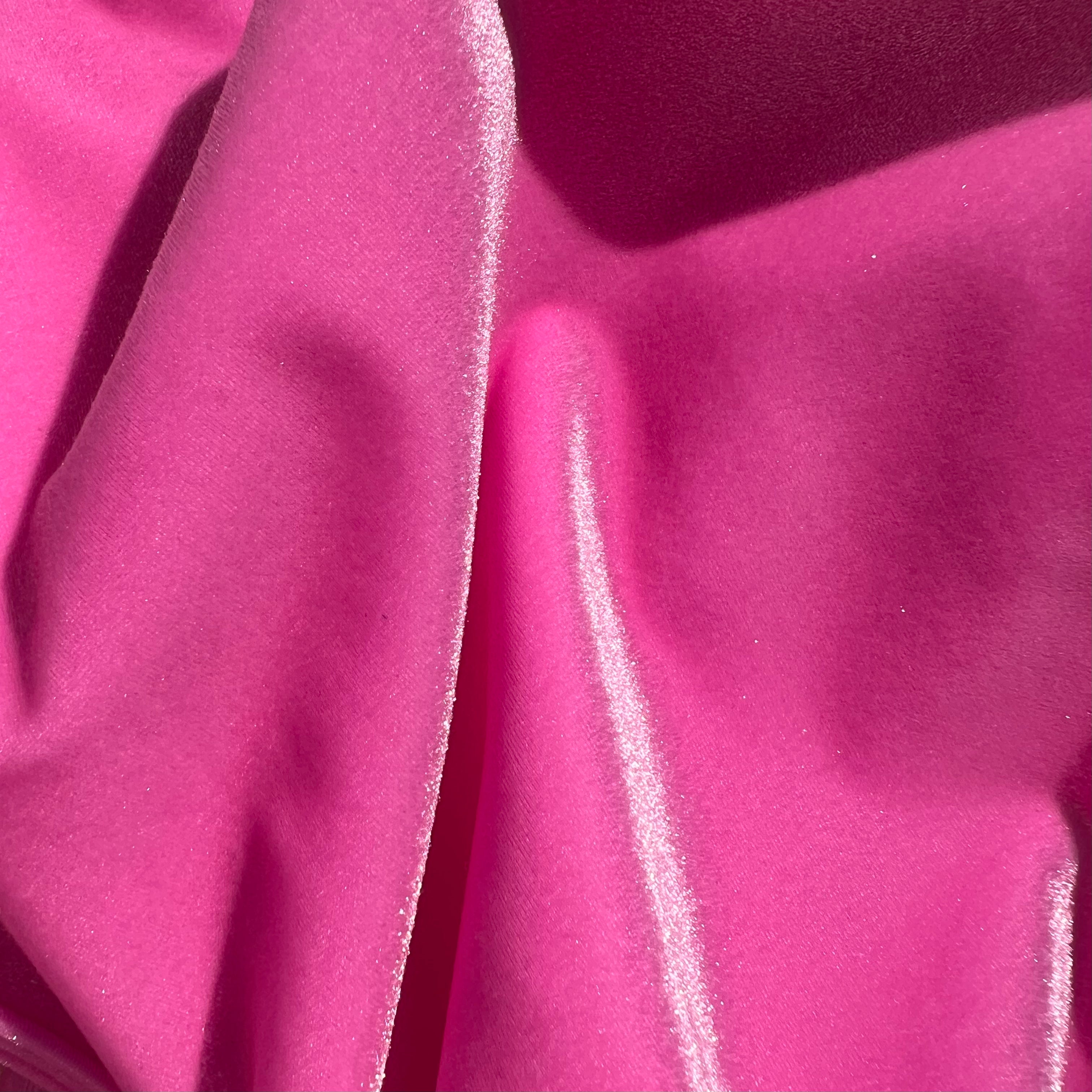 Close up photo of a pink velvet bikini from Baddie Beach Fantasy Collection, showcasing the iridescence of the fabric in the sun.
