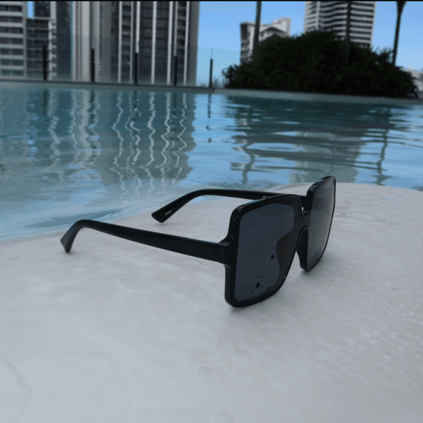 Rock the beach with Coco Shades! Oversized, square black sunglasses with UV400, perfect for any sunny setting. Comes with a custom case.