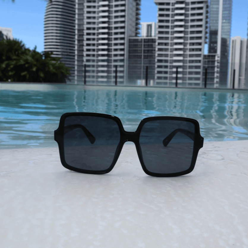 Rock the beach with Coco Shades! Oversized, square black sunglasses with UV400, perfect for any sunny setting. Comes with a custom case.